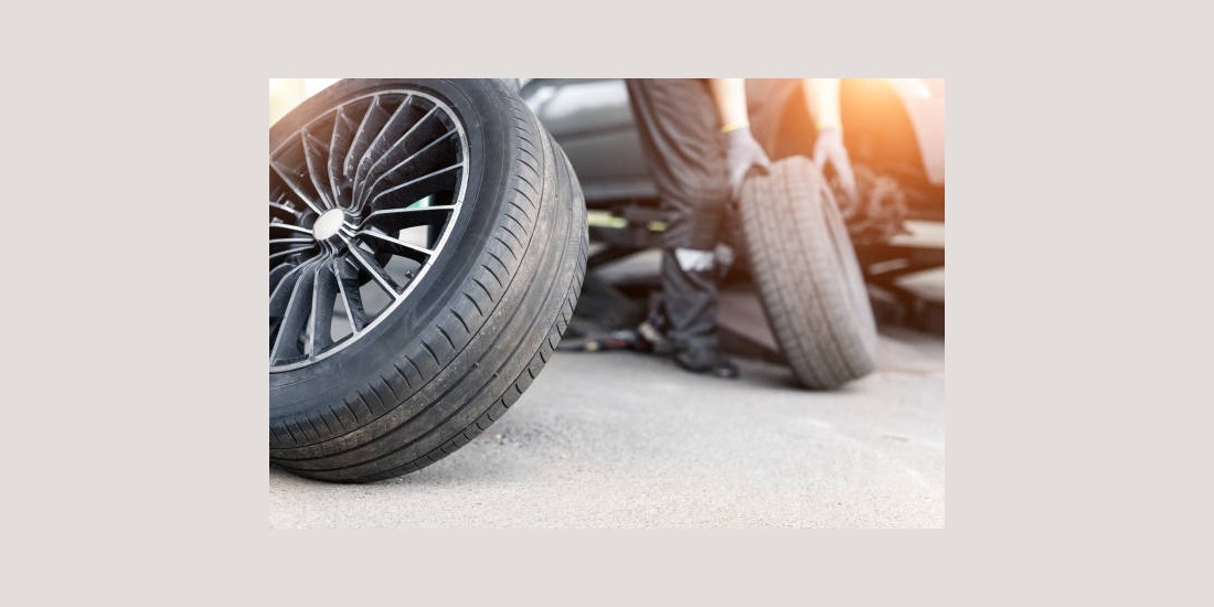Car wheel repair shop outdoor ground . Seasonal winter tyre change at workshop. Vehicle tire repair, inspection and maintenance. Automotive garage for replace spare parts after failure breakdown.